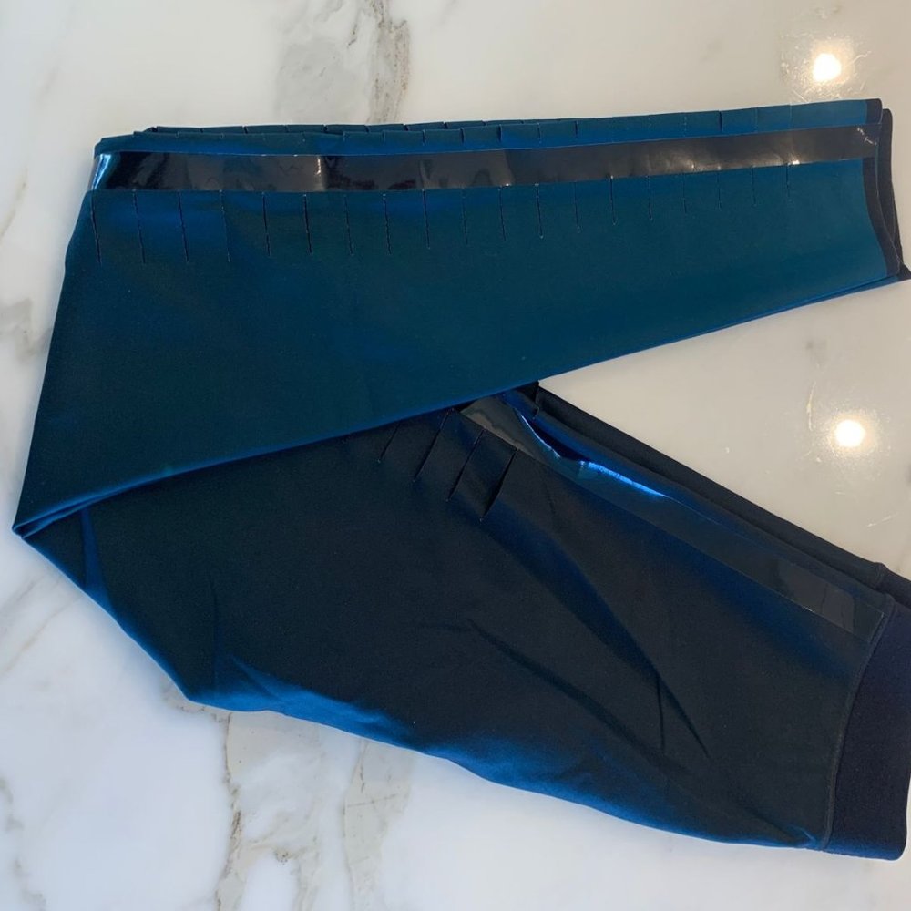 Ultracor blue leggings with black leather on the sides.